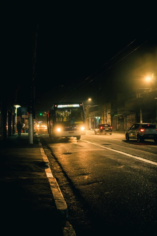 a bus driving down a street at night, inspired by Elsa Bleda, small town, silent hill in real life, north melbourne street, trending photo