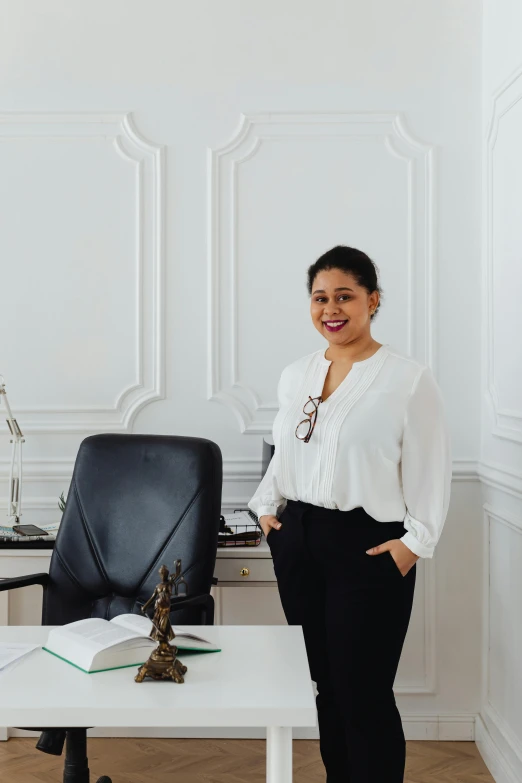 a woman standing next to a desk in an office, by Olivia Peguero, 30 years old woman, professional profile photo