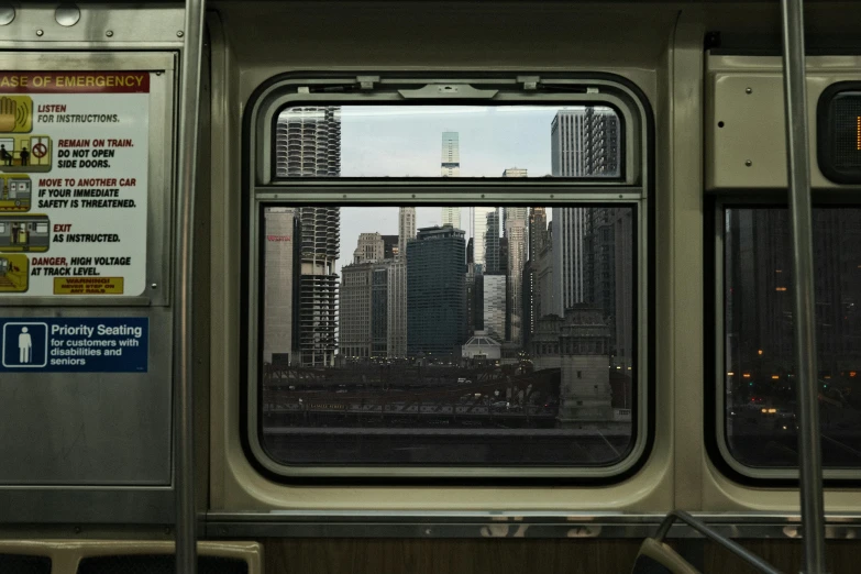 cityscape viewed through a window of a subway car
