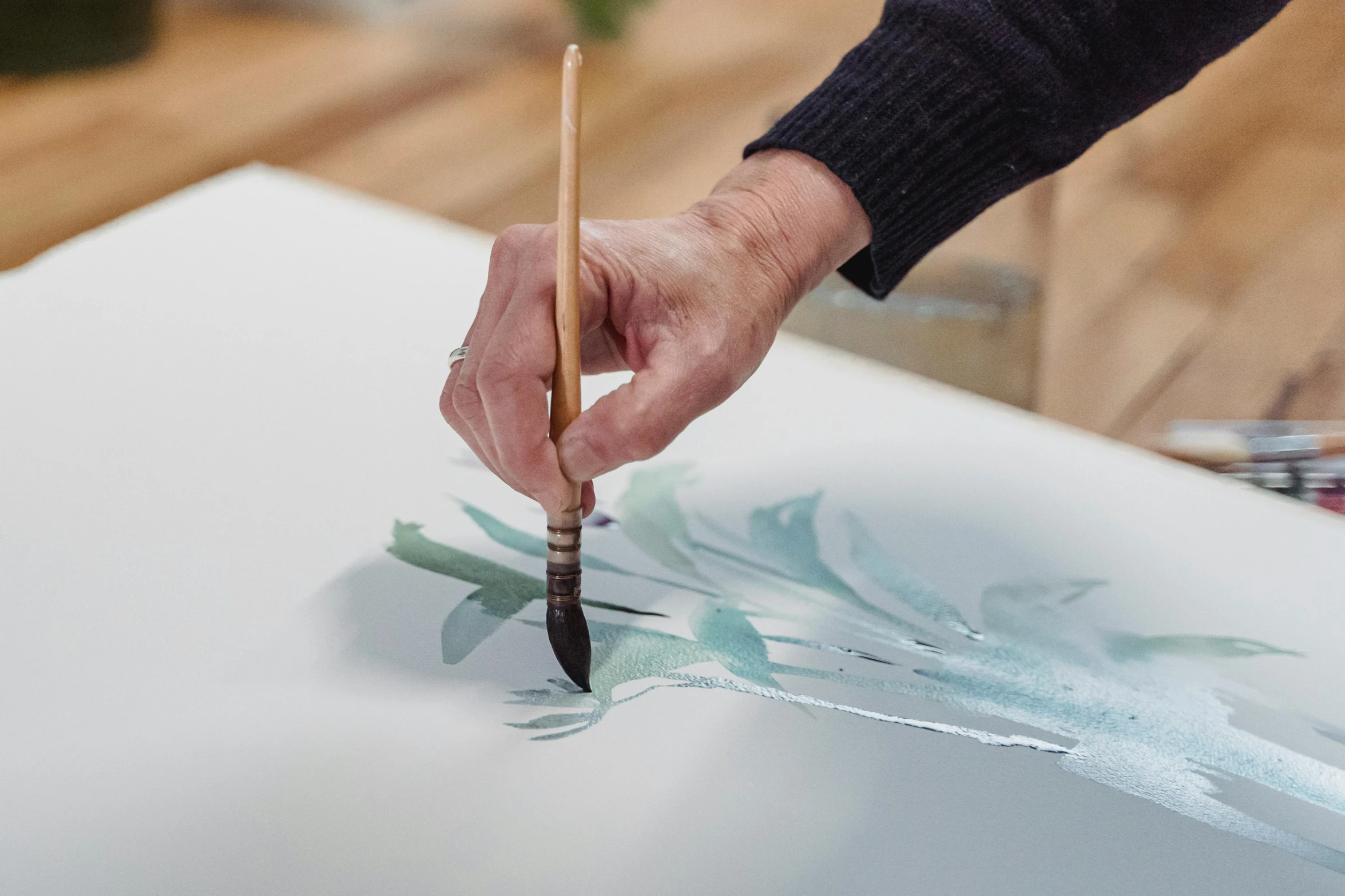 a close up of a person painting with a brush, a photorealistic painting, inspired by Friedel Dzubas, trending on unsplash, botanical drawing, water colour, elegant drawing, olan mills studio