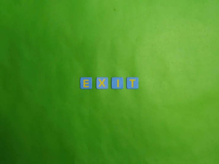 a green surface with two tiles spelling it