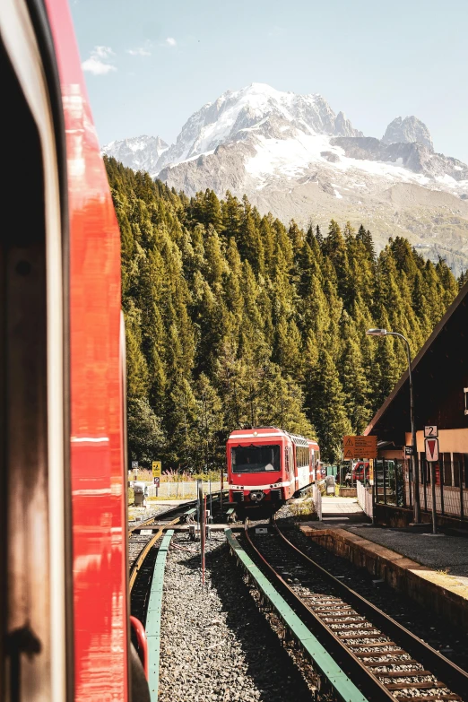 an image of train tracks with a mountain behind it