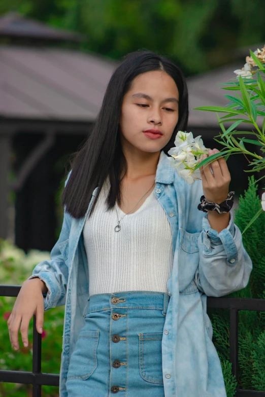 a  walking down the street while holding onto flowers