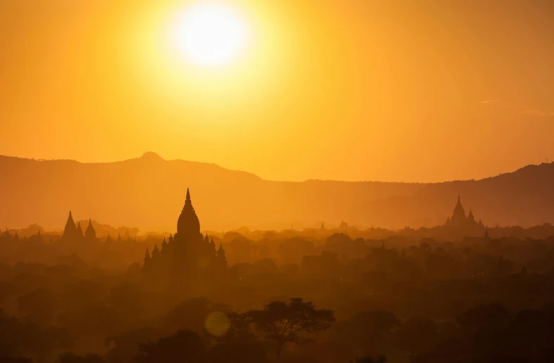 the sun is setting over the city of bagan, unsplash contest winner, romanticism, yellow, hazy, fan favorite, lpoty