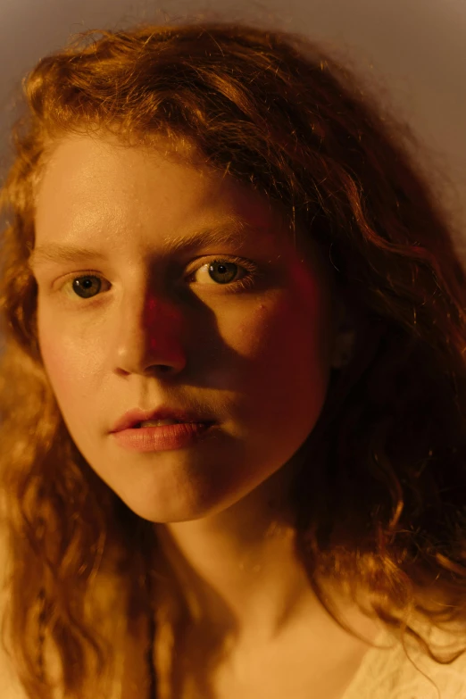 a close up of a person with long hair, inspired by Nan Goldin, renaissance, with curly red hair, teenager, under a spotlight, perfectly lit. movie still