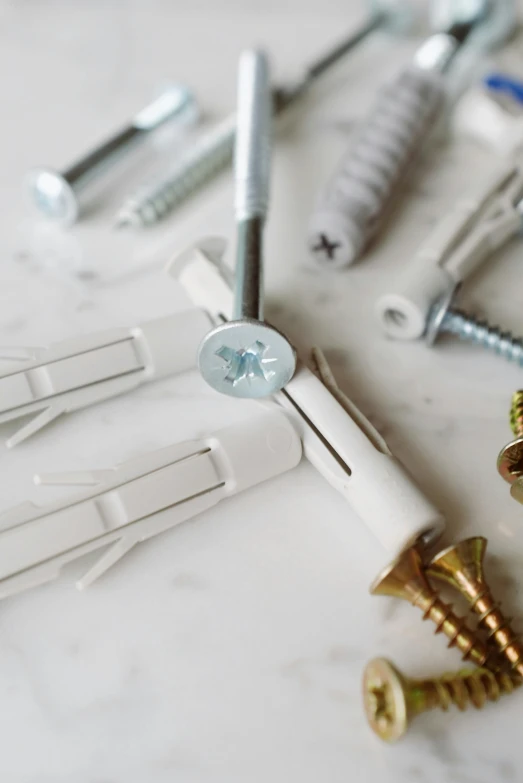 a bunch of screws sitting on top of a table, inspired by Cerith Wyn Evans, unsplash, white furniture, product view, clamp, various colors