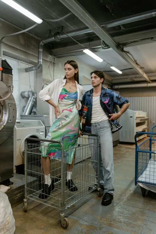 a couple of women standing next to a washing machine, trending on pexels, process art, scene from live action movie, in an underground laboratory, gucci clothes, silo