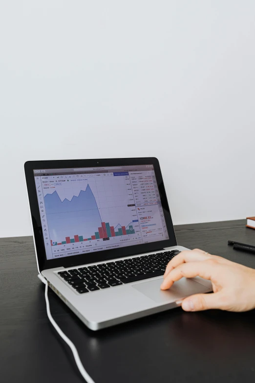 a woman sitting at a desk using a laptop computer, trending on unsplash, analytical art, displaying stock charts, 2 5 6 x 2 5 6 pixels, dark. no text, car trading game