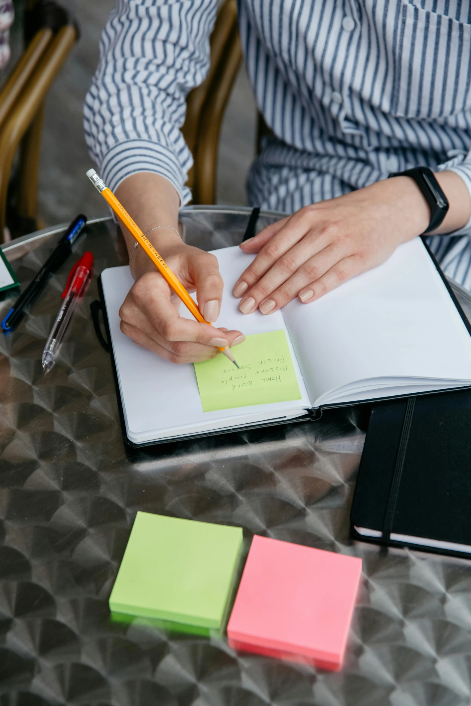 a woman sitting at a table writing in a notebook, square, multicoloured, thumbnail, inspect in inventory image