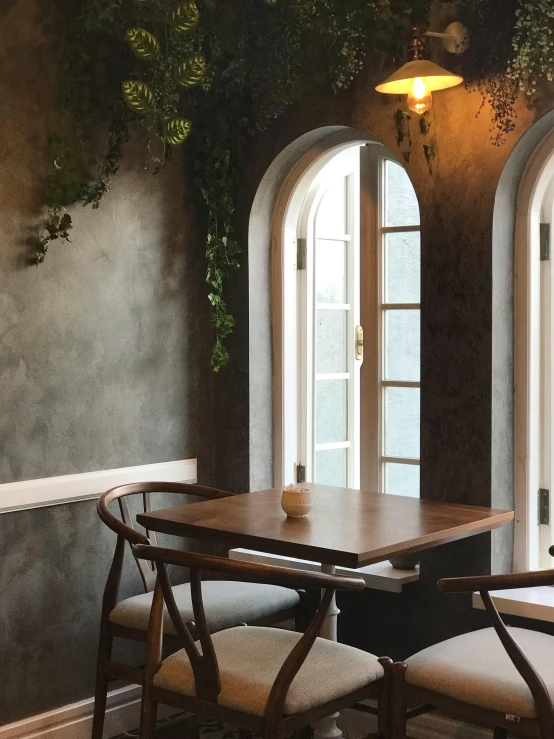 two chairs are set at a small wooden table