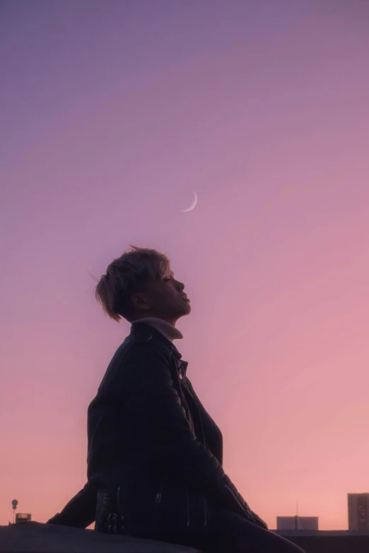 a woman sitting on a ledge looking at the sky, an album cover, by Jang Seung-eop, trending on pexels, aestheticism, crescent moon, androgynous person, pastel sunset, johan liebert