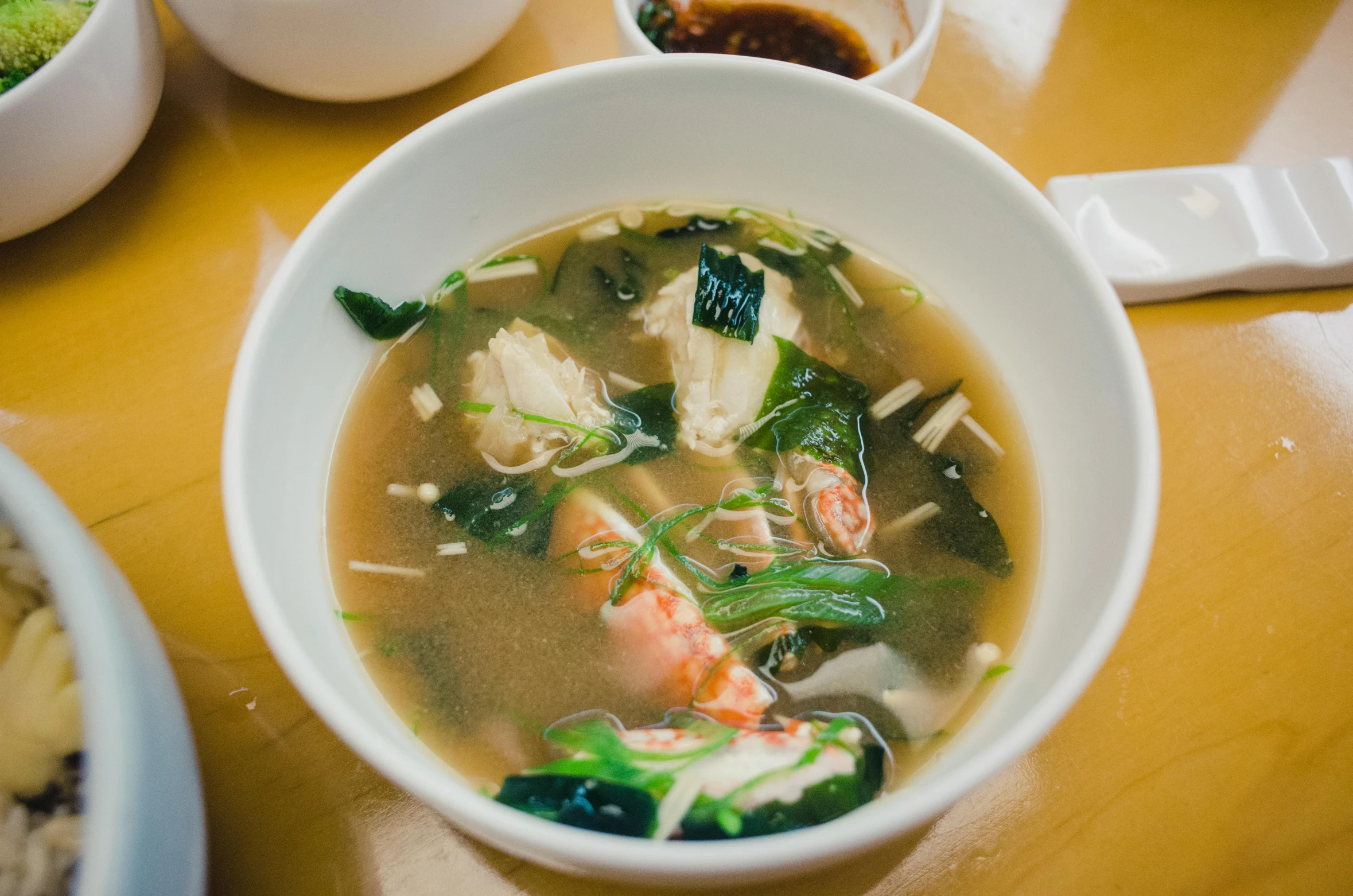 bowl of soup with a lot of broth and vegetables