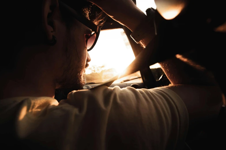 a man holding a cell phone up to his ear, pexels contest winner, sun shines down on the car, on a hot australian day, avatar image, gnarly details soft light