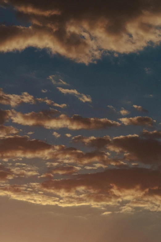 a couple of giraffe standing on top of a lush green field, an album cover, unsplash, romanticism, layered stratocumulus clouds, golden hour 4k, ((sunset)), cumulus clouds