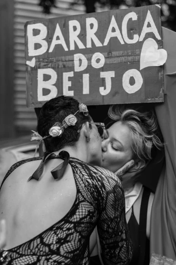 a couple of people that are kissing each other, a black and white photo, by Silvia Pelissero, dada, jair bolsonaro, are-bure-boke!!!!!!!!, lesbian, protest