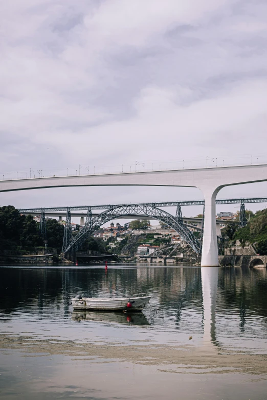 a body of water with a bridge in the background, by Nadir Afonso, exterior, all around, exterior view, showing curves