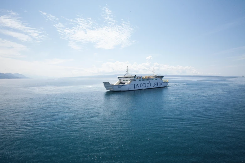 large passenger boat in open water on clear day