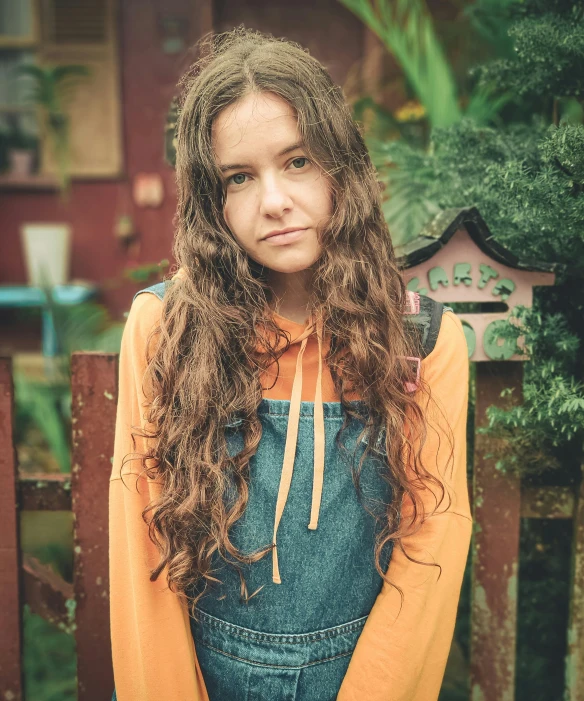 a beautiful young woman sitting on top of a wooden bench, an album cover, by Else Alfelt, unsplash, renaissance, wearing overalls, she has long orange brown hair, headshot, kids