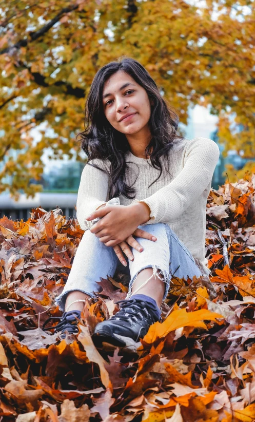 a woman sitting on top of a pile of leaves, mia khalifa, wears brown boots, ( ( emma lindstrom ) ), 15081959 21121991 01012000 4k