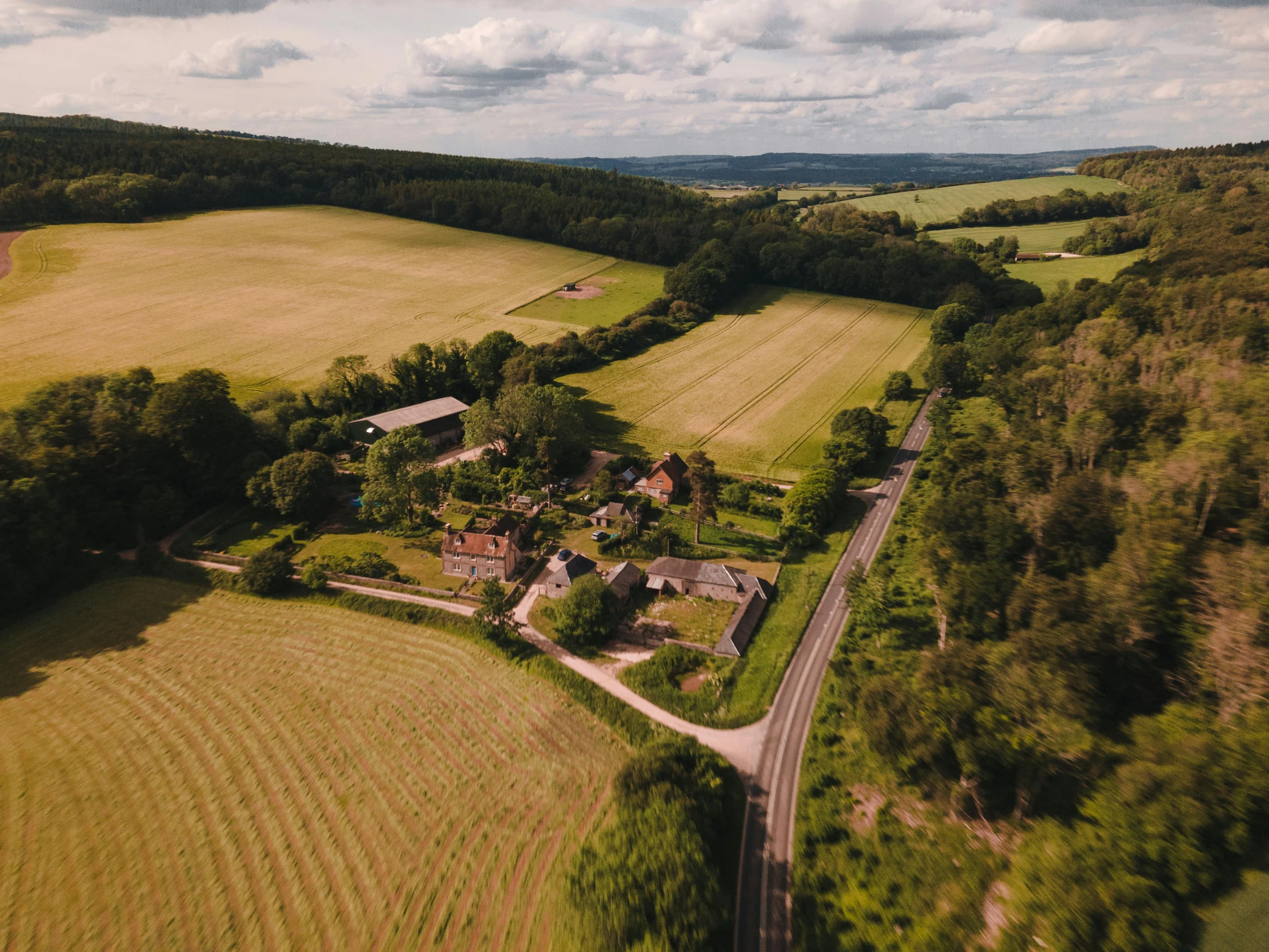 a rural area with several roads, many houses and trees