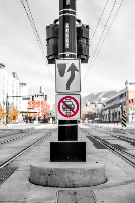 a pole has several signs on it on a city street