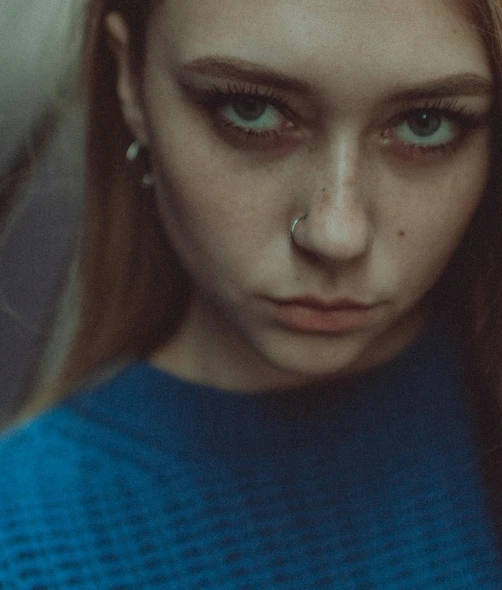 a close up of a person with long hair, a character portrait, inspired by Elsa Bleda, trending on pexels, teenager girl, piercing stare, bluish face, shaved face