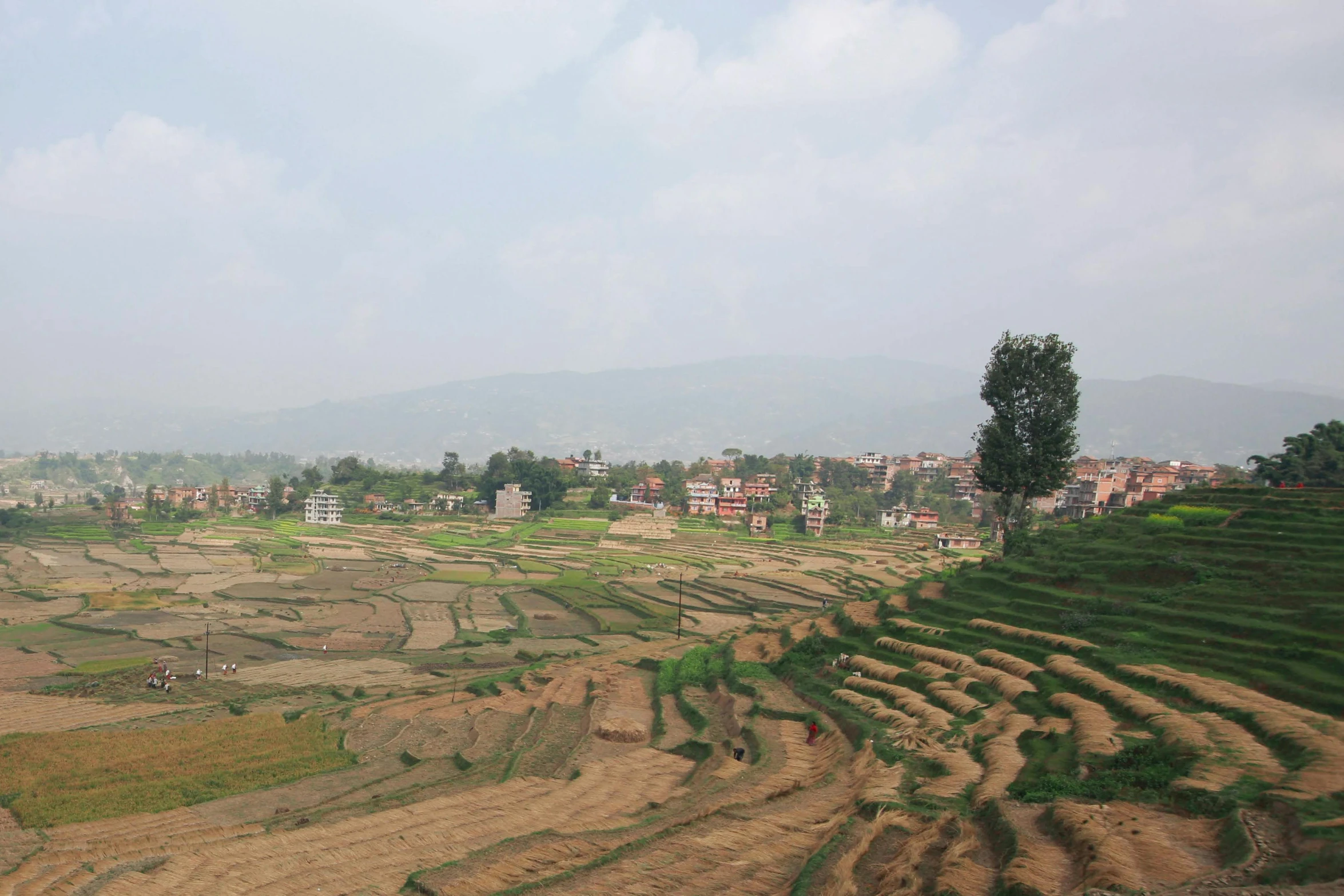 a village sitting on top of a hill in the middle of a rural area