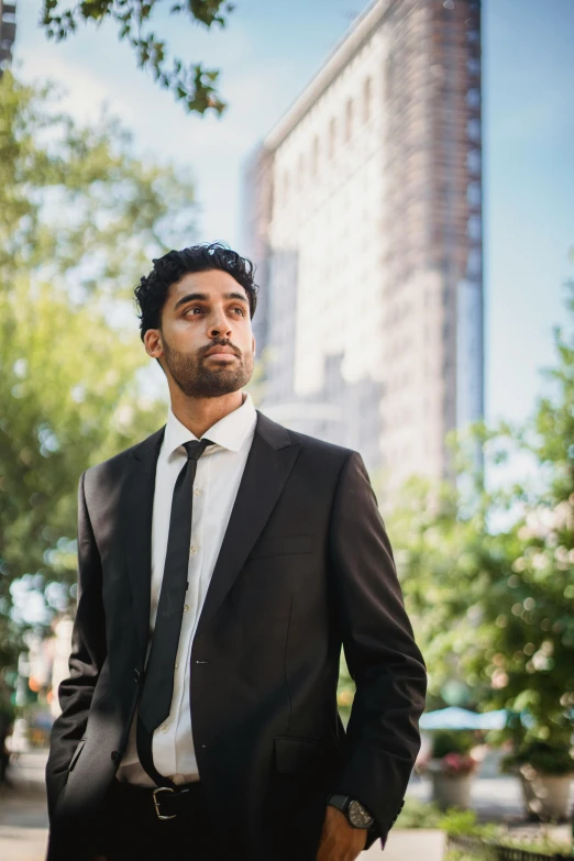 a young man in a suit is posing for the camera