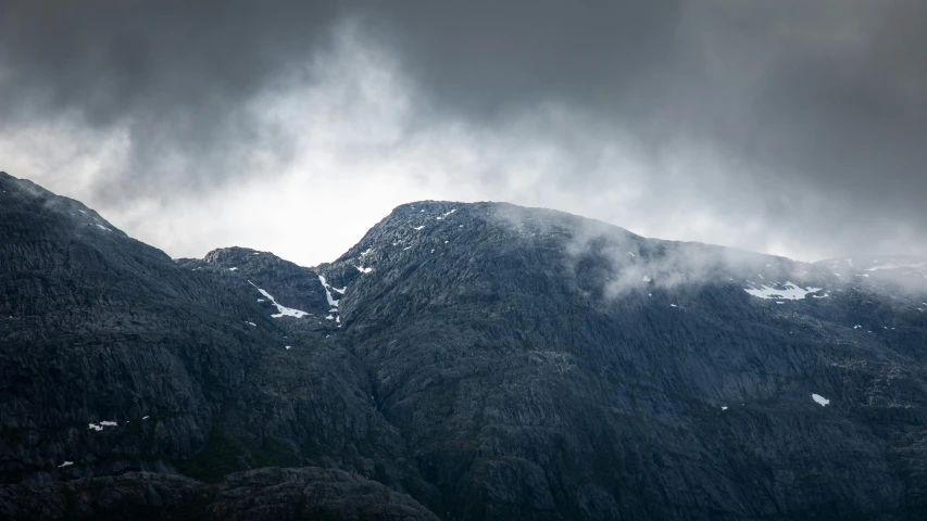 the mountains are shown under the clouds as they move