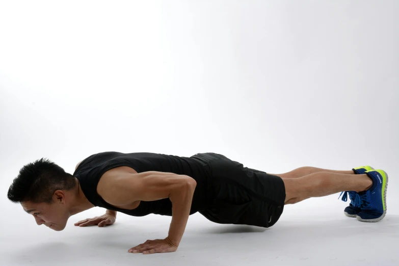 a man doing push ups against a white background, pexels contest winner, biomechanics, photo of barack obama, yoga, malaysian