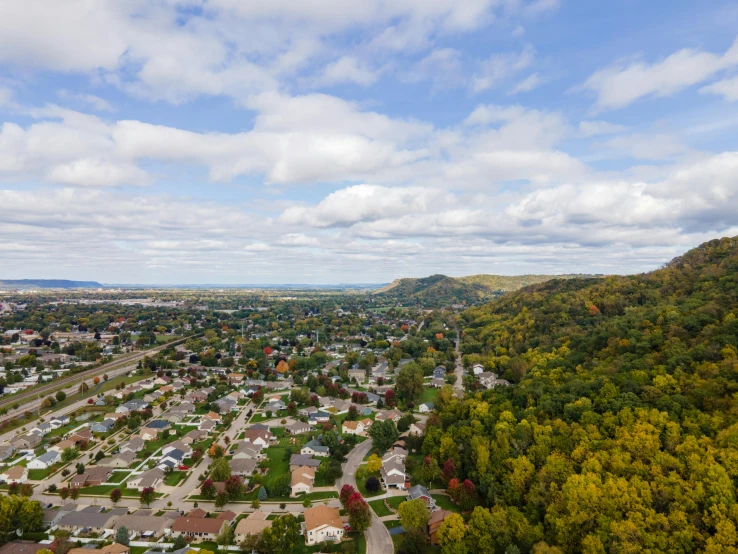 a town with houses in it nestled at the top of a hill