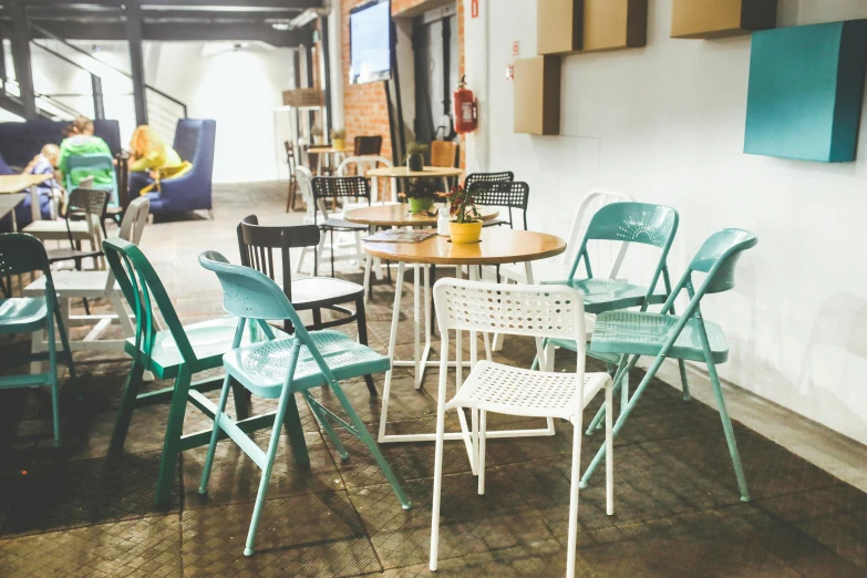 a set of four dining chairs sitting around a table