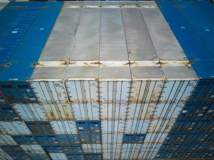 a stack of containers stacked on top of each other, by Daniel Lieske, unsplash, photorealism, spaceship hull texture, blue metal, high-angle, full pallet image