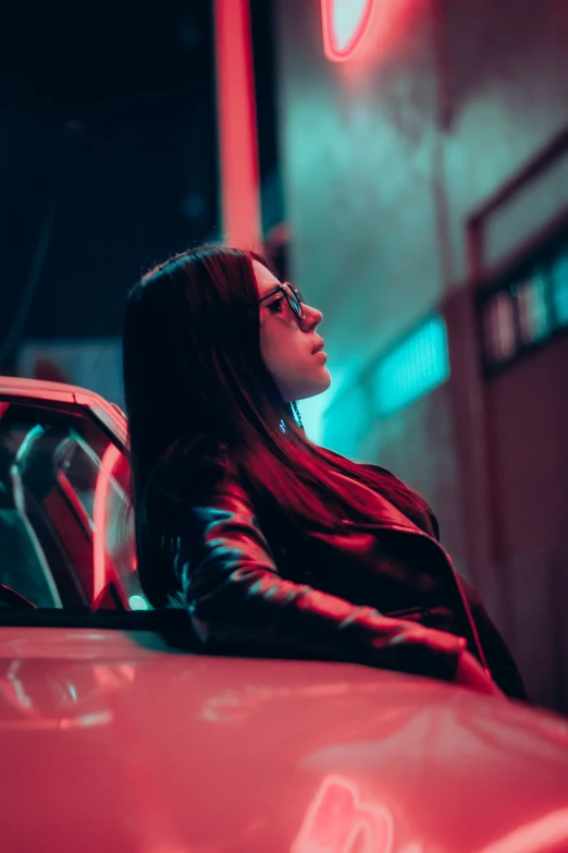 a woman leaning on a car while looking off in distance