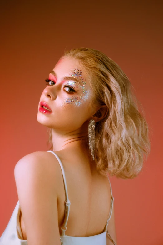 a woman in a white dress with glitter on her face, an album cover, inspired by Elsa Bleda, trending on pexels, star butterfly, a young asian woman, platinum blonde, infrared hair