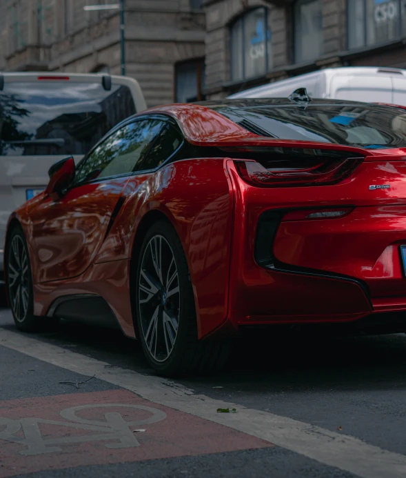 a red sports car parked on the side of the road, by Adam Marczyński, pexels contest winner, bmw i 8, hyperdetailed!, zoomed in, back facing