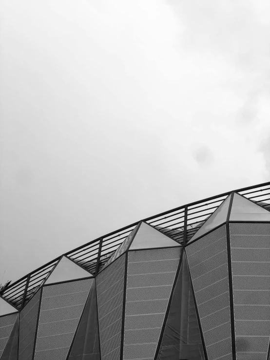 a black and white photo of a building, by Emma Geary, unsplash contest winner, soccer stadium, geodesic, overcast gray skies, colours