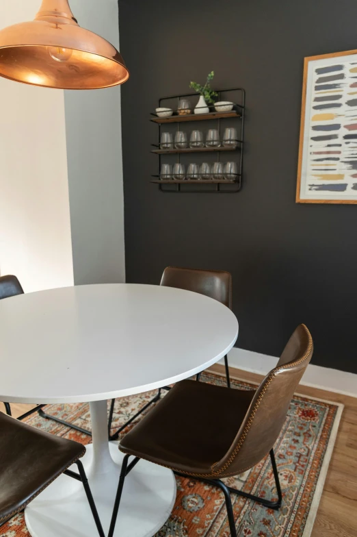 a white table with four chairs next to it