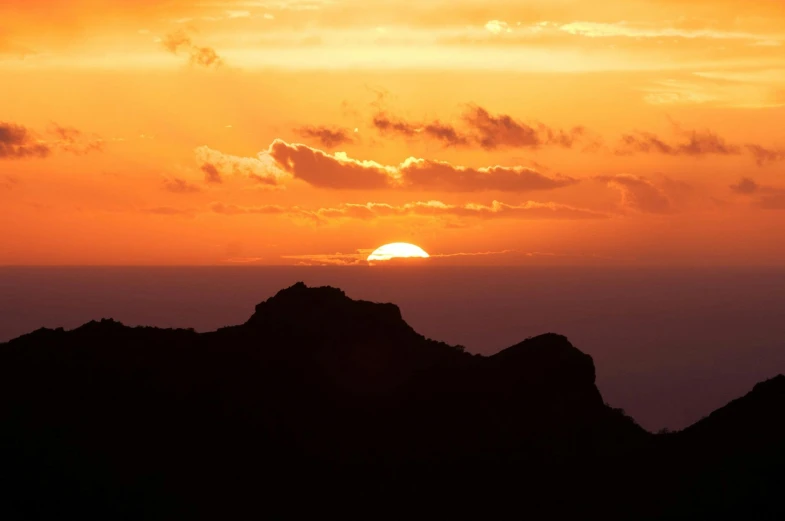 the sun is setting over a mountain range, pexels contest winner, romanticism, in socotra island, monserrat gudiol, orange sun set, fine art print