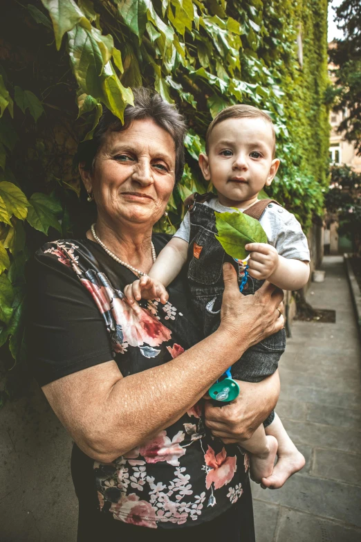 a woman with a baby wearing a pink shirt