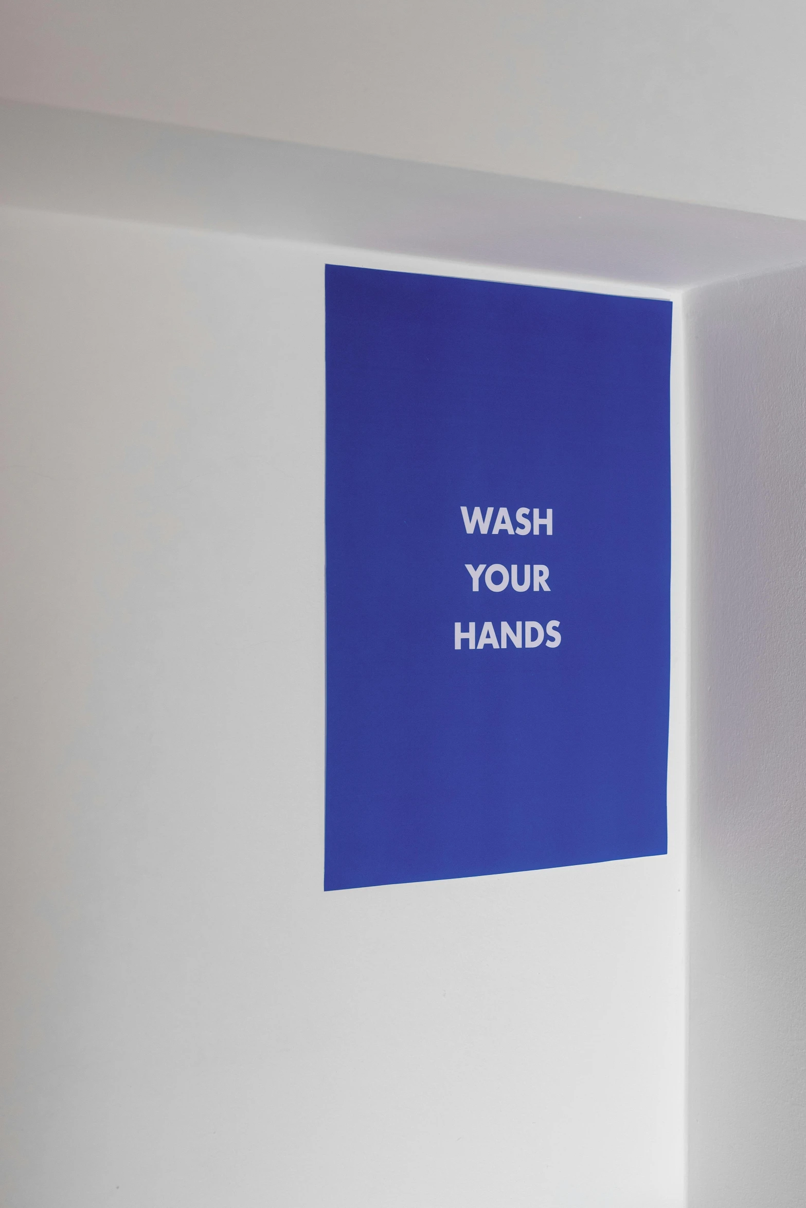 a bathroom with a wash your hands sign on the wall, a poster, inspired by Yves Klein, unsplash, visual art, ffffound, cloth banners, healthcare, julia hetta