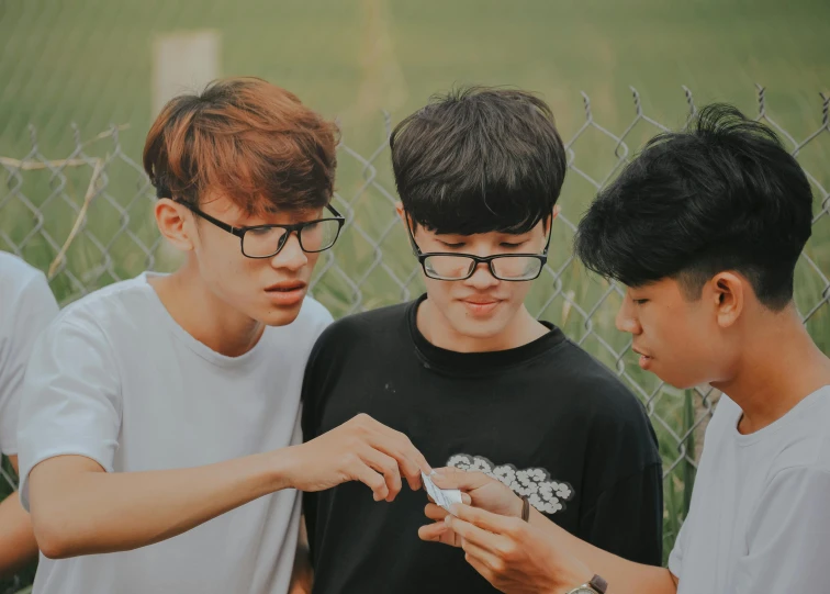 a group of young men standing next to each other, a picture, by Jang Seung-eop, trending on pexels, happening, mobile game, with glasses, teenage boy, mtg card trading