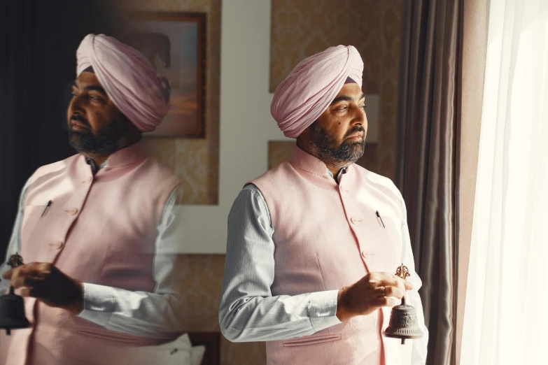 a man in a pink turban standing in front of a mirror, inspired by Sardar Sobha Singh, pexels contest winner, film promotional still, in his suit, at dawn, promotional image