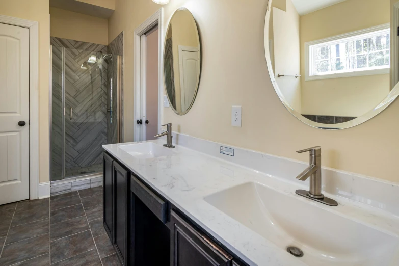 a bathroom with two sinks and mirror above it