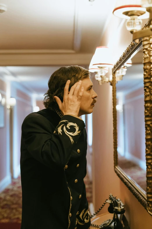 a man is wearing a black uniform while talking on the phone