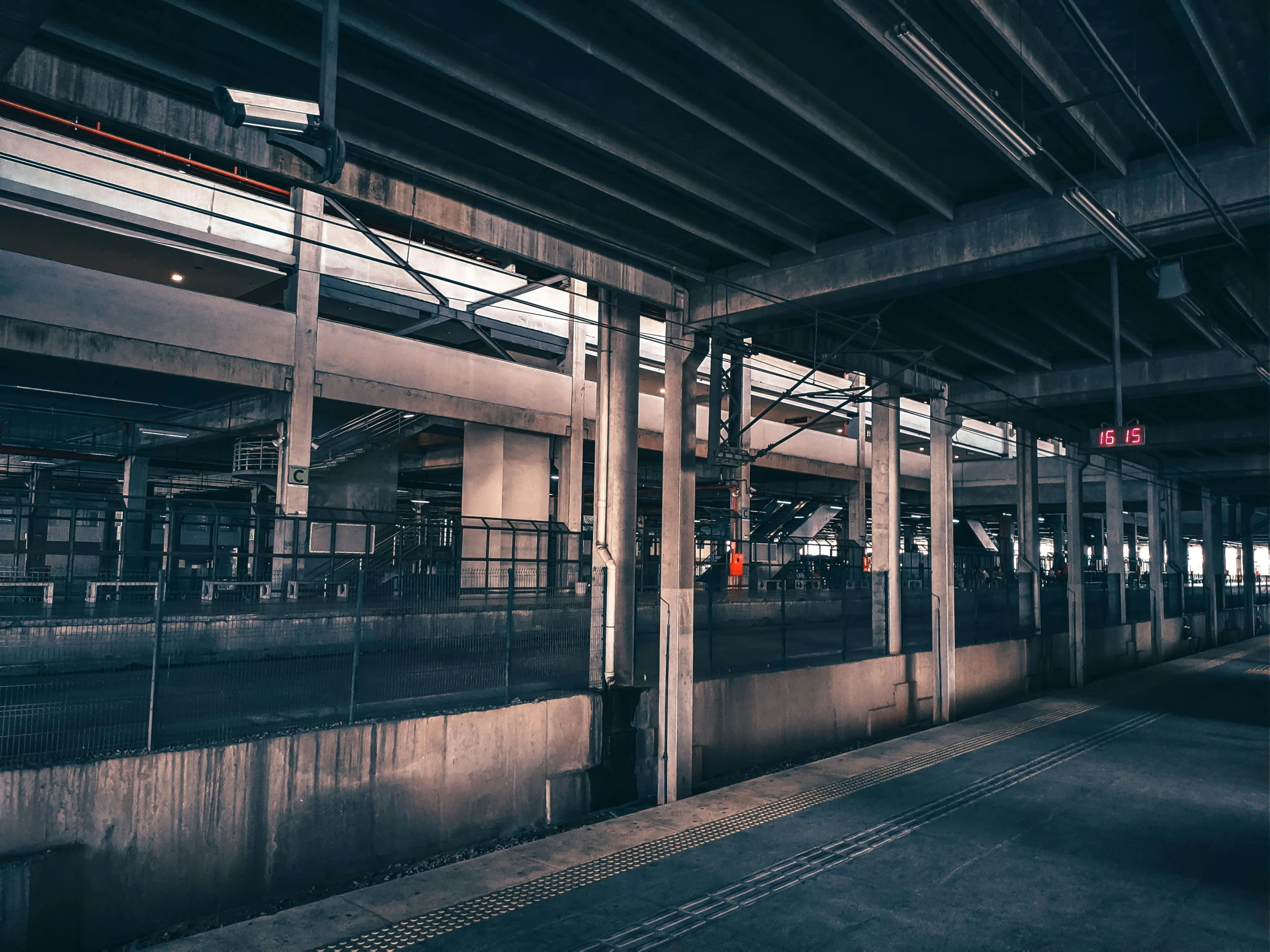 a train pulling into a train station next to a platform, a picture, unsplash, brutalism, factory floor, instagram photo, [ cinematic, kyoto inspired