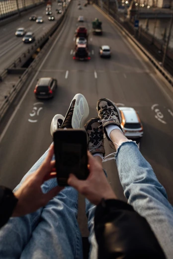 a person on a phone that is taking a picture of cars and traffic