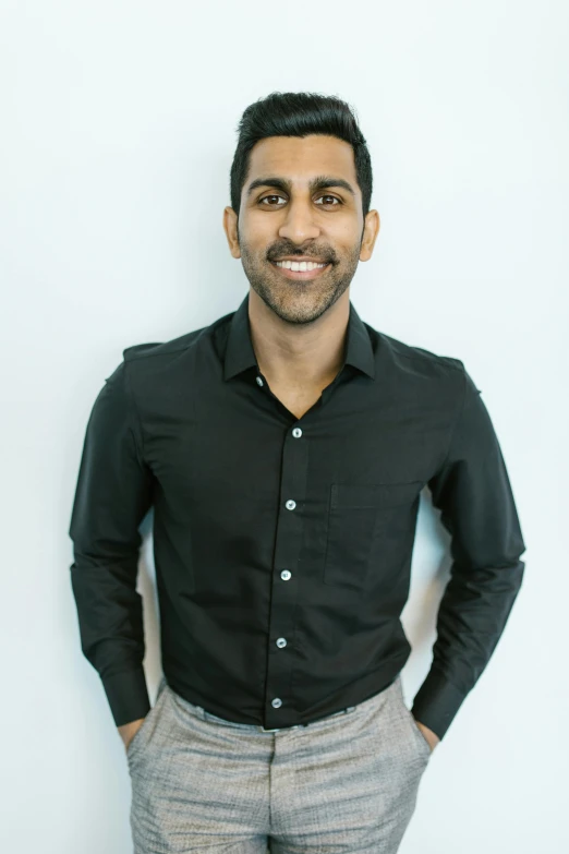 a man standing with his hands in his pockets, a picture, jayison devadas, wearing business casual dress, smiling down from above, alex kanevsky