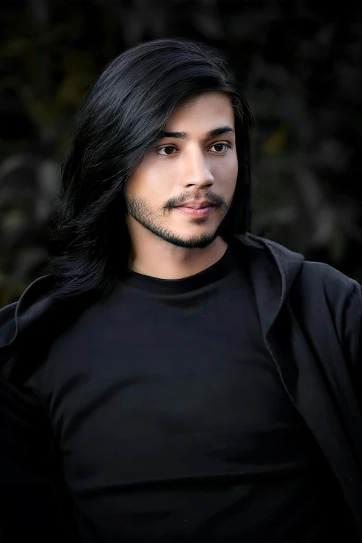 an artistic po of a man with long black hair