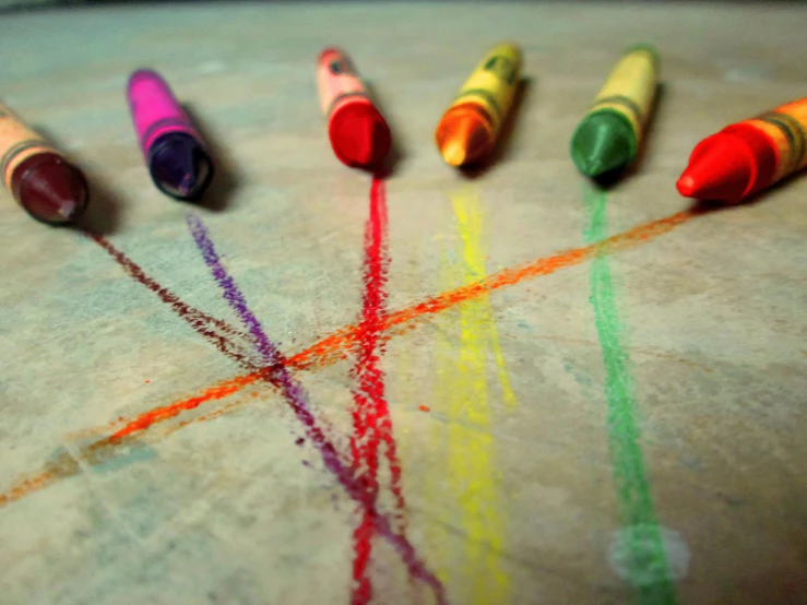 rainbow crayons are laid out on the floor